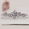 Round diamond ring with vintage filigree detail set in polished white gold.