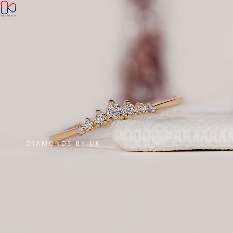 Prong set wedding band designed with seven round diamonds.
