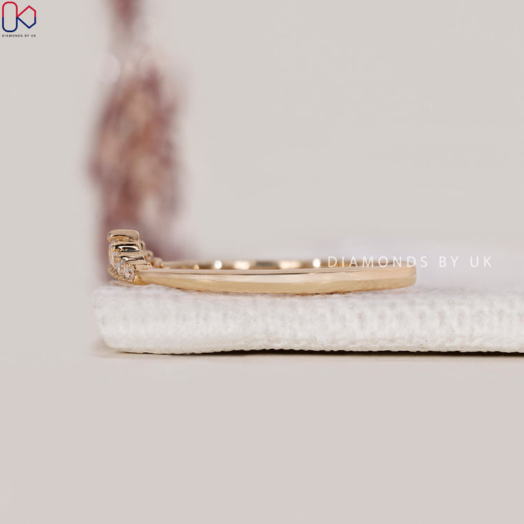 Custom wedding band with round cut diamonds in prong setting.
