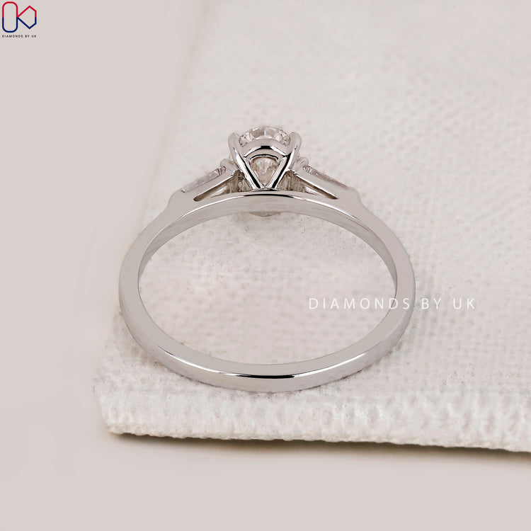 Customize ring with cathedral setting and side diamonds.
