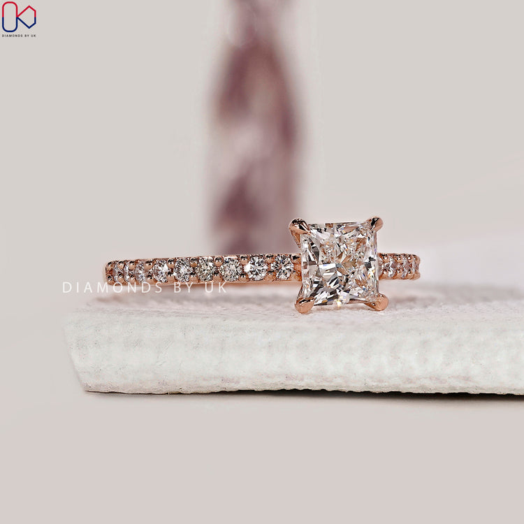 Handmade princess cut ring with round diamond accents.