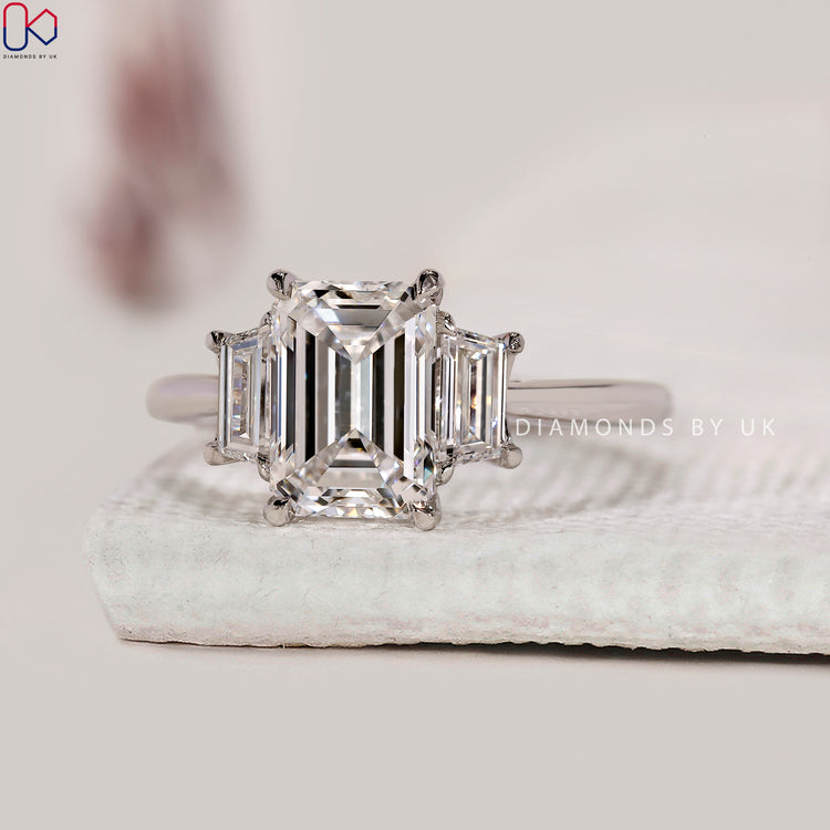 Tapered shank ring featuring three diamond layout.
