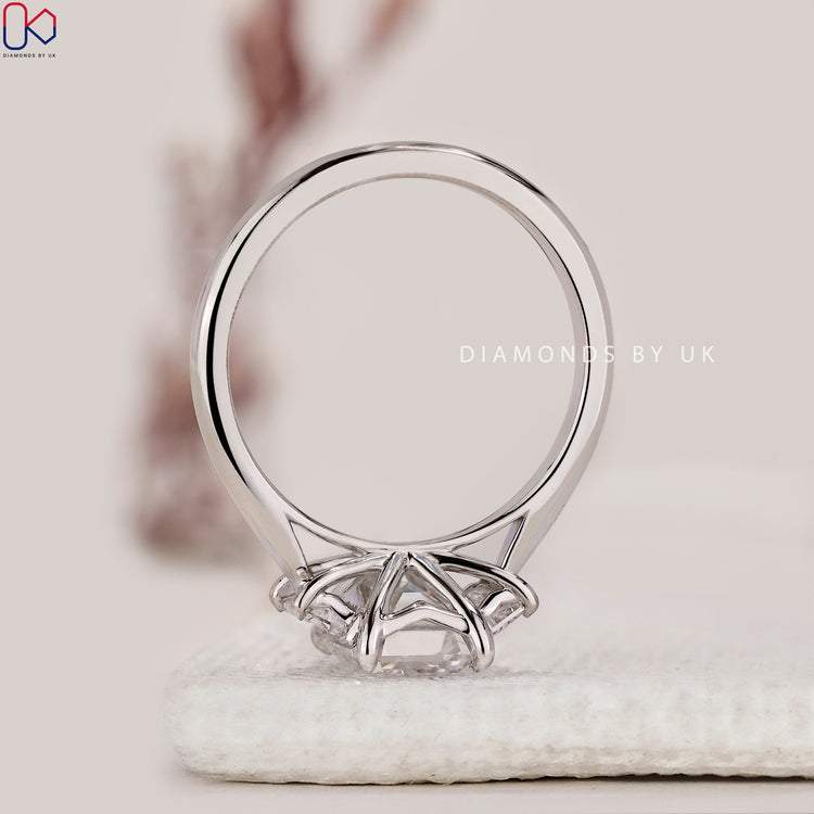 Custom engagement ring with emerald cut and tapered shank.
