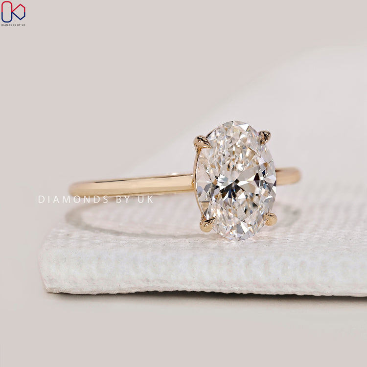 Handmade oval engagement ring by DiamondsbyUK.
