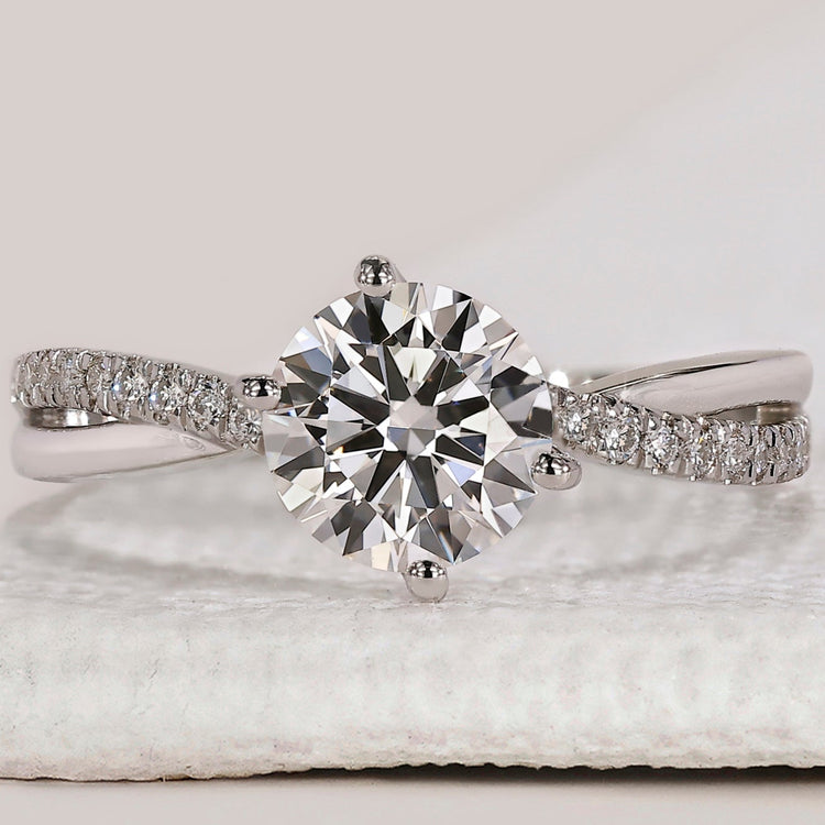 White gold engagement ring with round diamond center.
