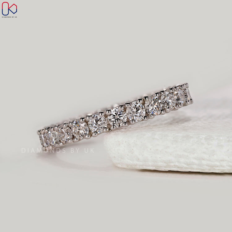 Prong setting band with custom diamond band in white gold.
