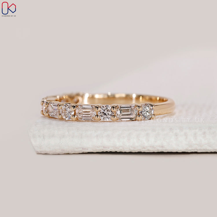 Handmade band with emerald and round diamonds.
