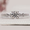 White gold engagement ring with a sleek 4-claw prong setting.
