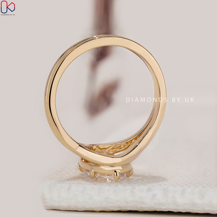 Yellow gold diamond ring with oval cut center.
