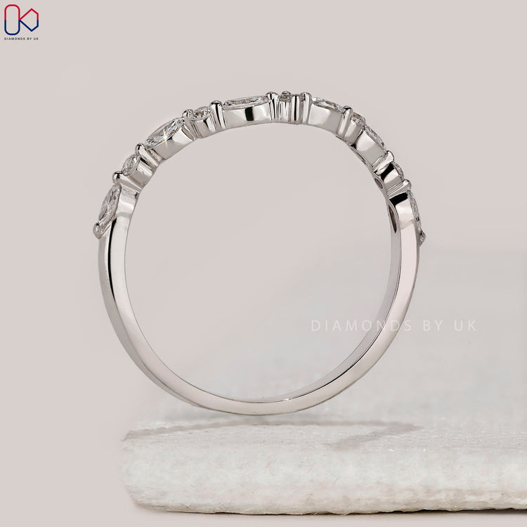 Handmade band with marquise and round diamonds.
