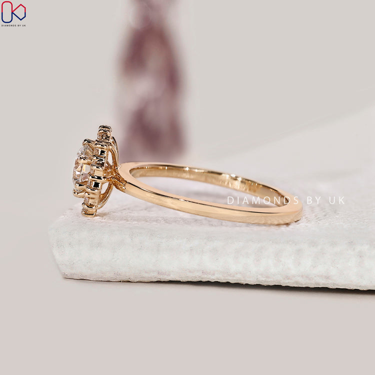 DiamondsbyUK round cut halo diamond ring in yellow gold.
