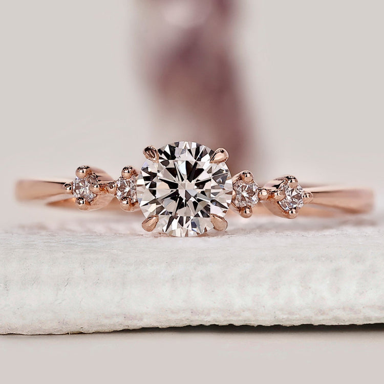 Five stone diamond engagement ring with round cut diamonds.
