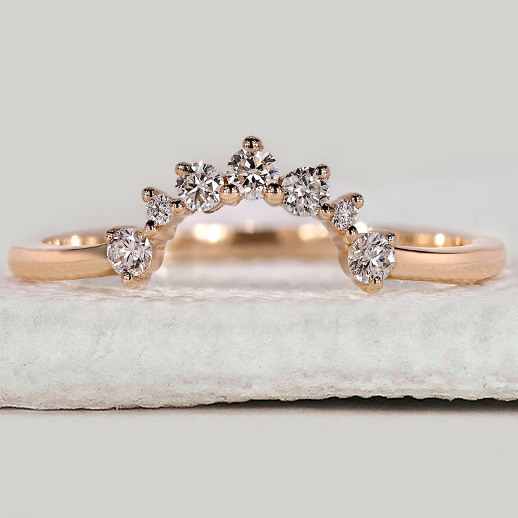 Round diamond wedding band with a polished yellow gold finish.
