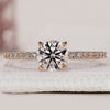 Round diamond engagement ring with pave setting.
