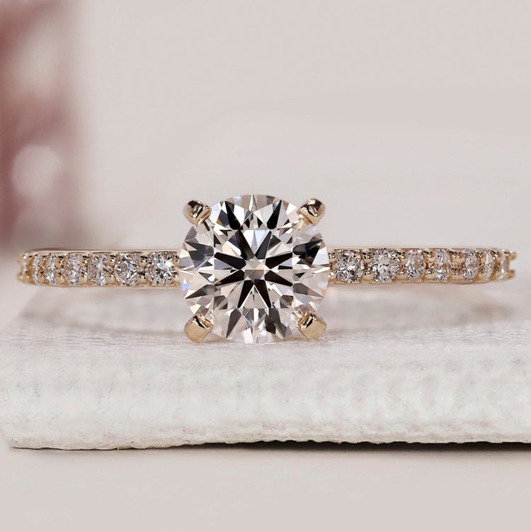 Round diamond engagement ring with pave setting.
