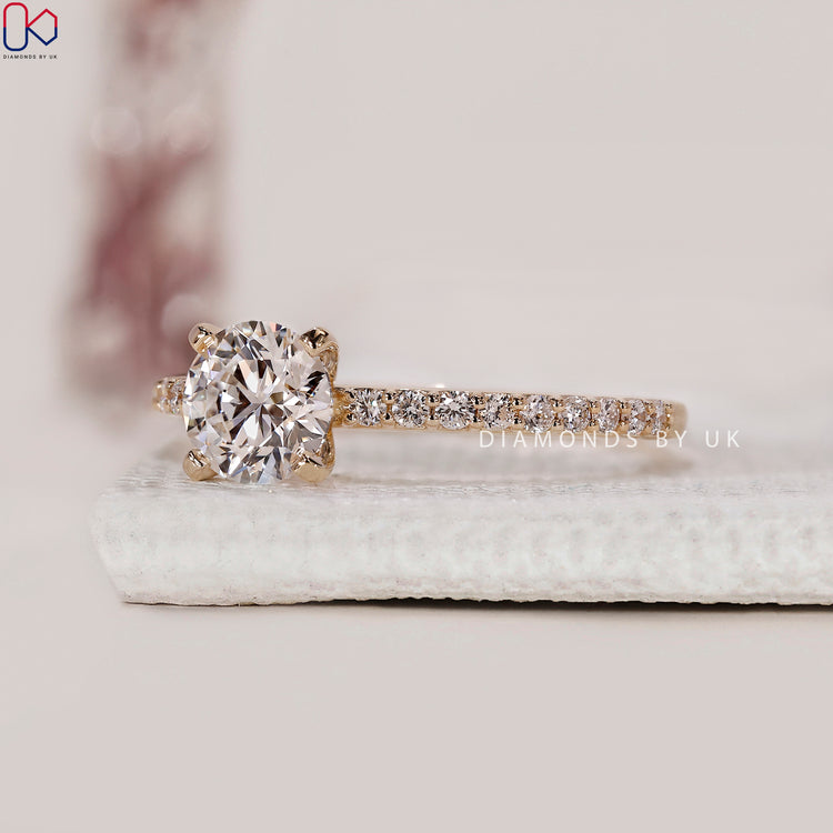 Yellow gold engagement ring featuring pave setting.
