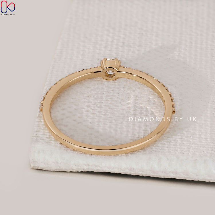 Yellow gold ring with double prong and round cut center stone.
