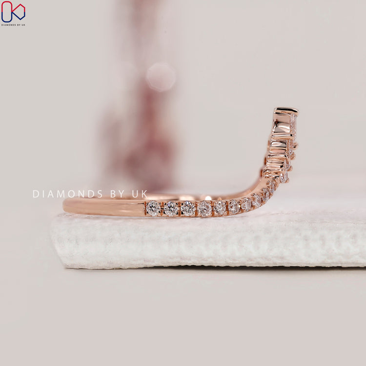 Prong setting band designed with pear and round stones in rose gold.
