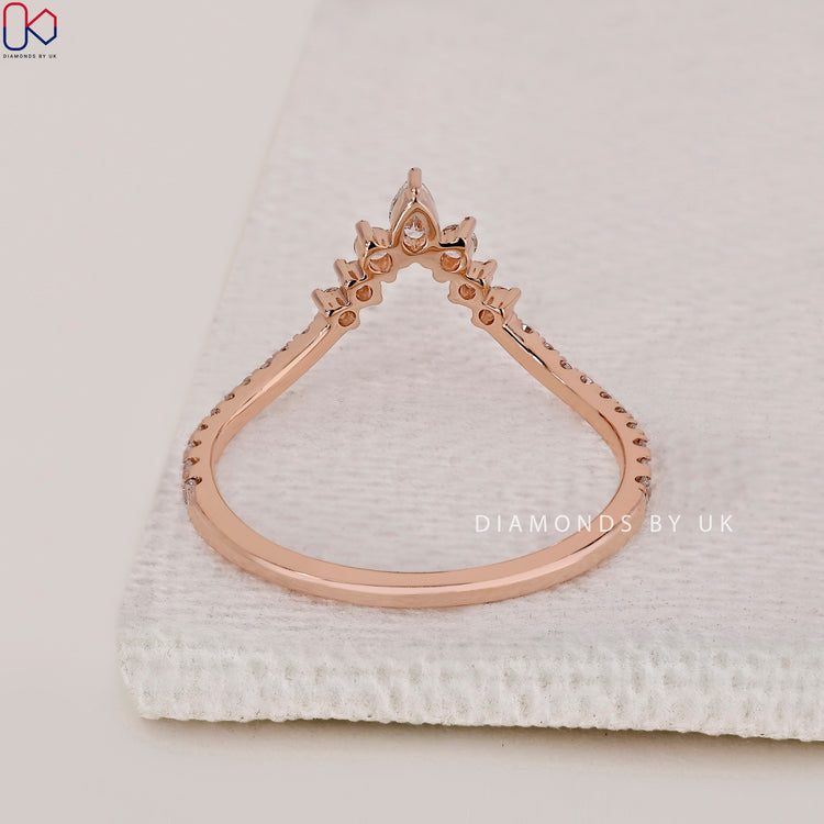 Handmade jewellery with pear and round diamonds in a curved setting.
