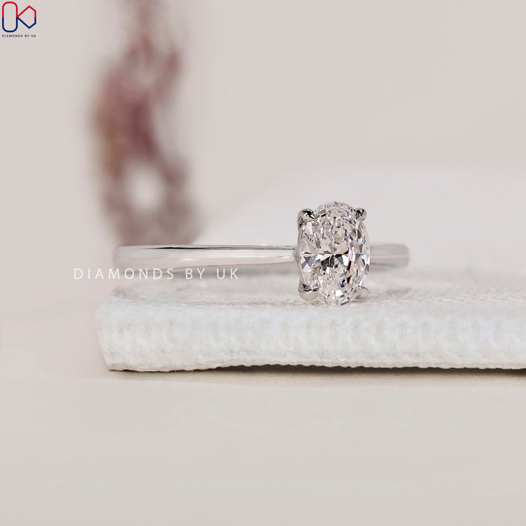 Tapered Shank Oval Cut Diamond Ring, set in a white gold band with a cathedral setting.