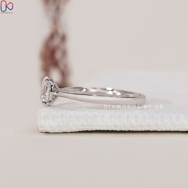 Cathedral Setting Oval Cut Diamond Ring, set in white gold with a tapered shank, perfect for a unique proposal ring.
