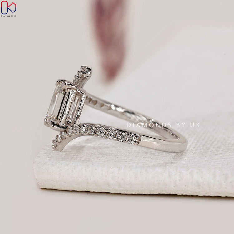 4 prong setting ring featuring emerald cut diamond.
