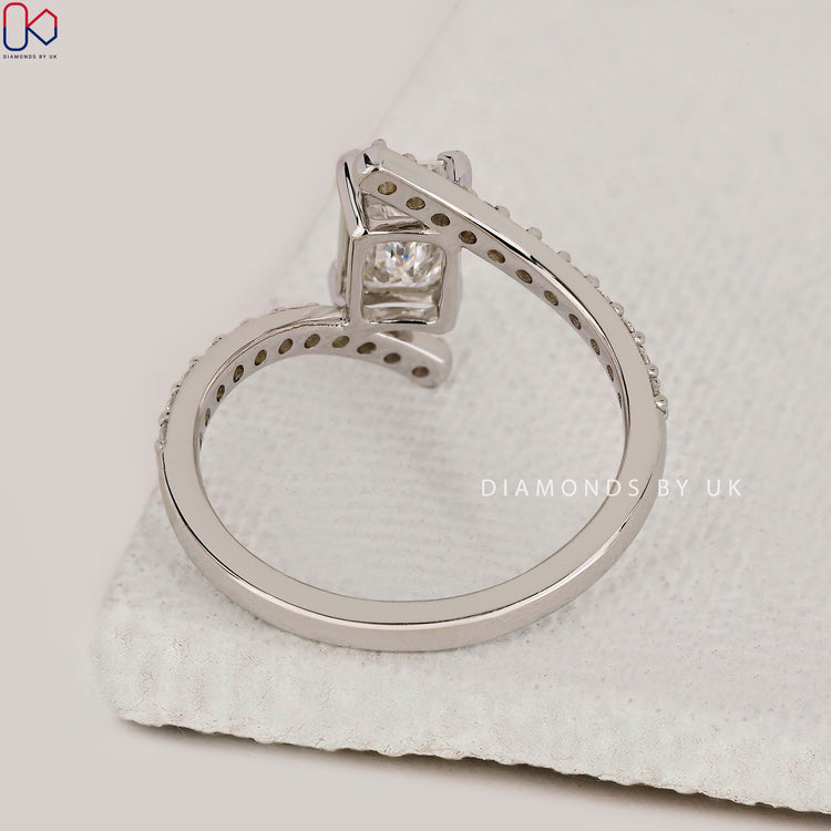 Bypass setting ring with lab grown emerald cut diamond.
