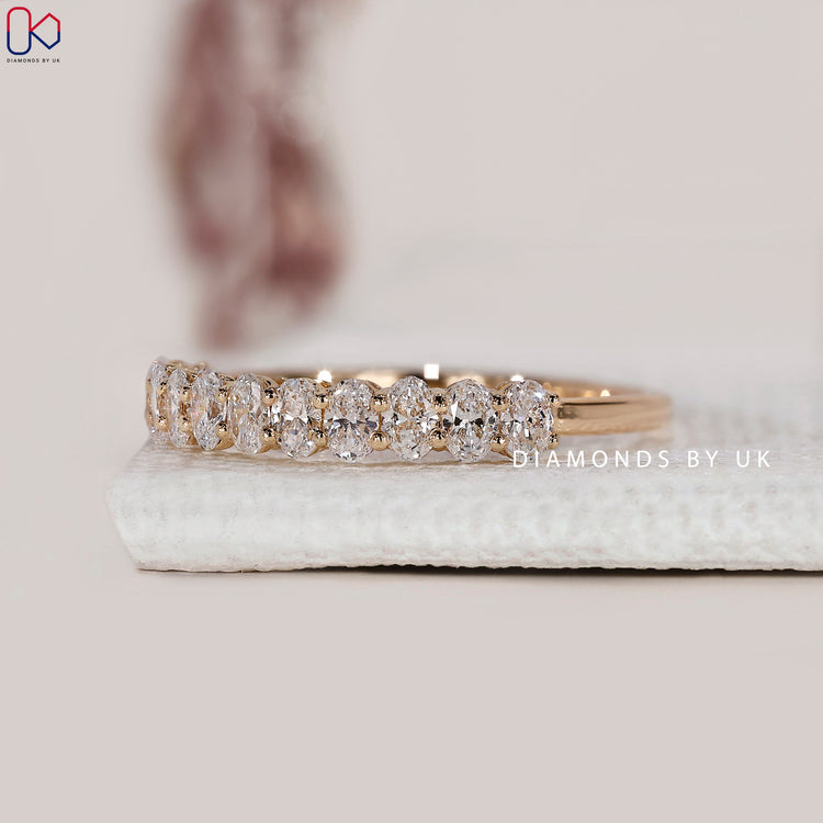 Custom yellow gold prong set diamond band.
