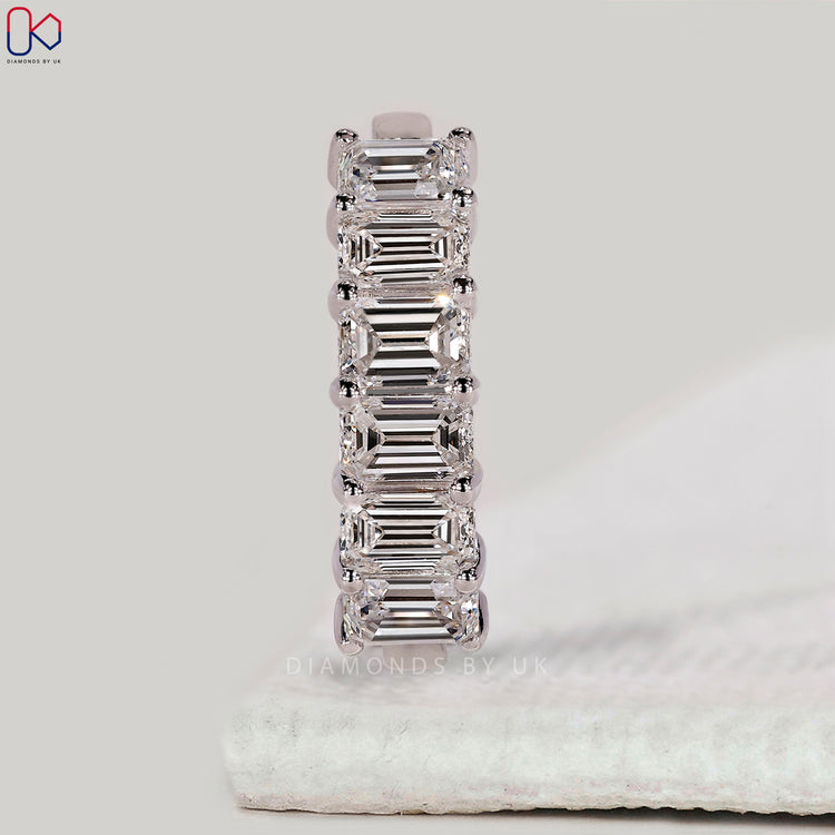 White gold wedding band with emerald cut diamonds.
