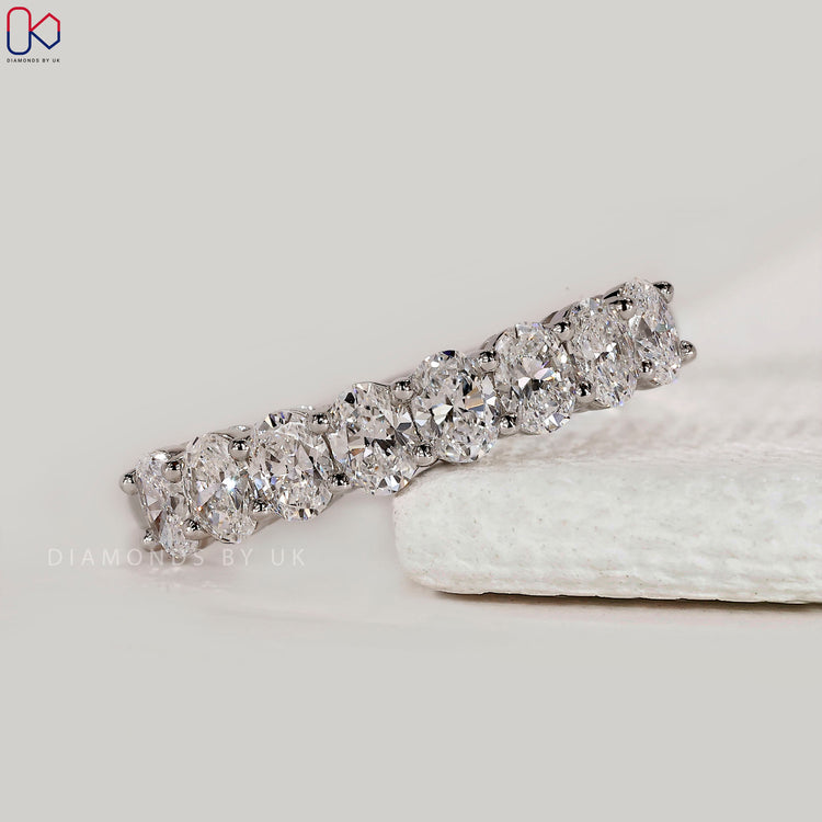 White gold band with oval diamonds.
