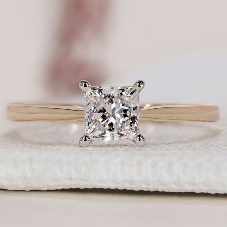 Solitaire ring with a princess cut diamond.
