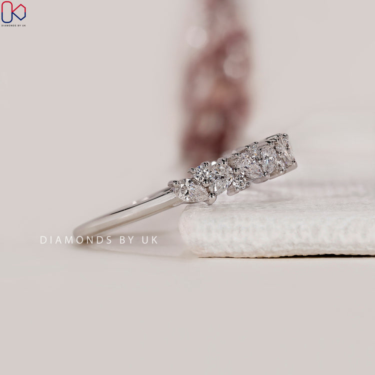 Buy diamond band featuring pear and round cut stones.
