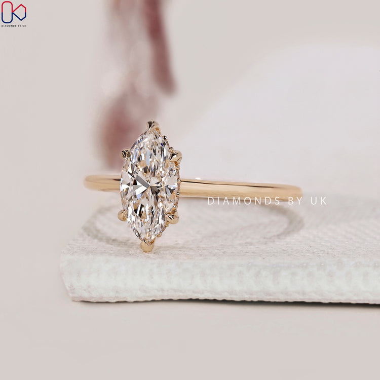 Hidden halo diamond ring featuring a brilliant marquise diamond.
