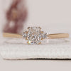 Cushion cut engagement ring with round cut side stones.
