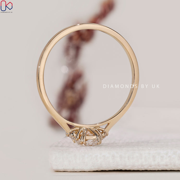 Cathedral setting ring with round and cushion cut stones.
