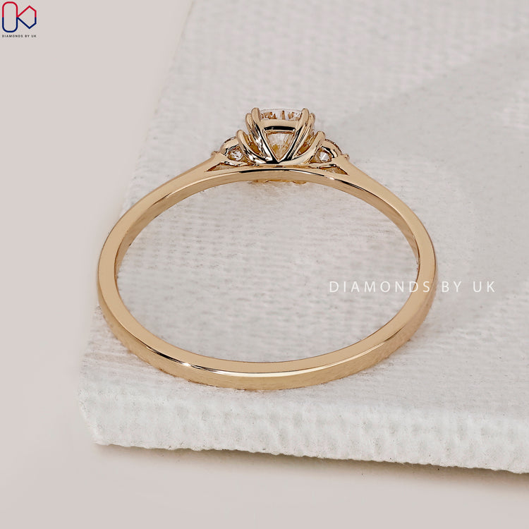 Yellow gold diamond ring with 3 stone layout.
