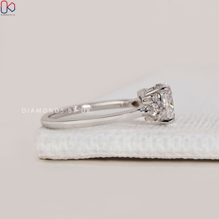 Custom Asscher cut engagement ring with round side stones.
