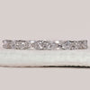 Pear shaped diamond band in shared prong setting.
