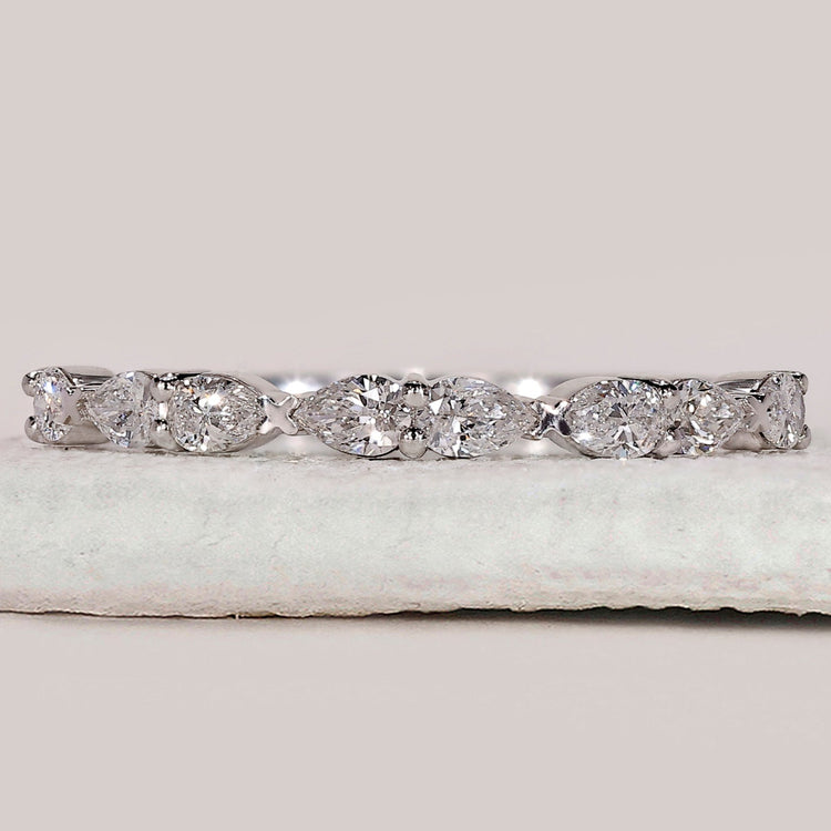 Pear shaped diamond band in shared prong setting.
