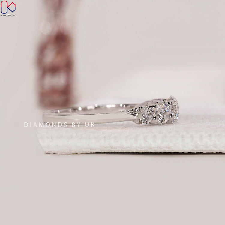 Prong setting band with five round diamonds.
