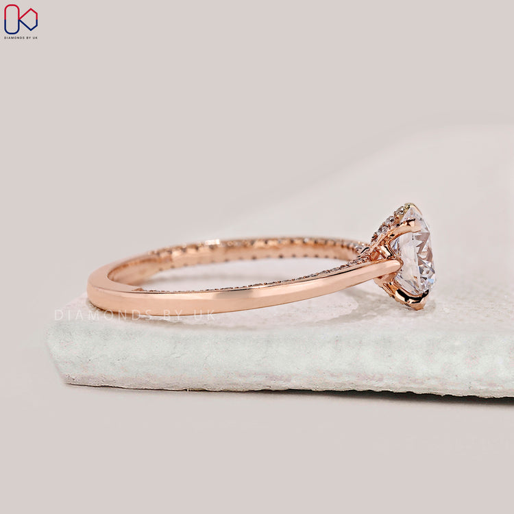 Tapered shank rose gold diamond engagement ring.

