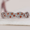 Twisted wedding band featuring sparkling diamonds for a unique design.
