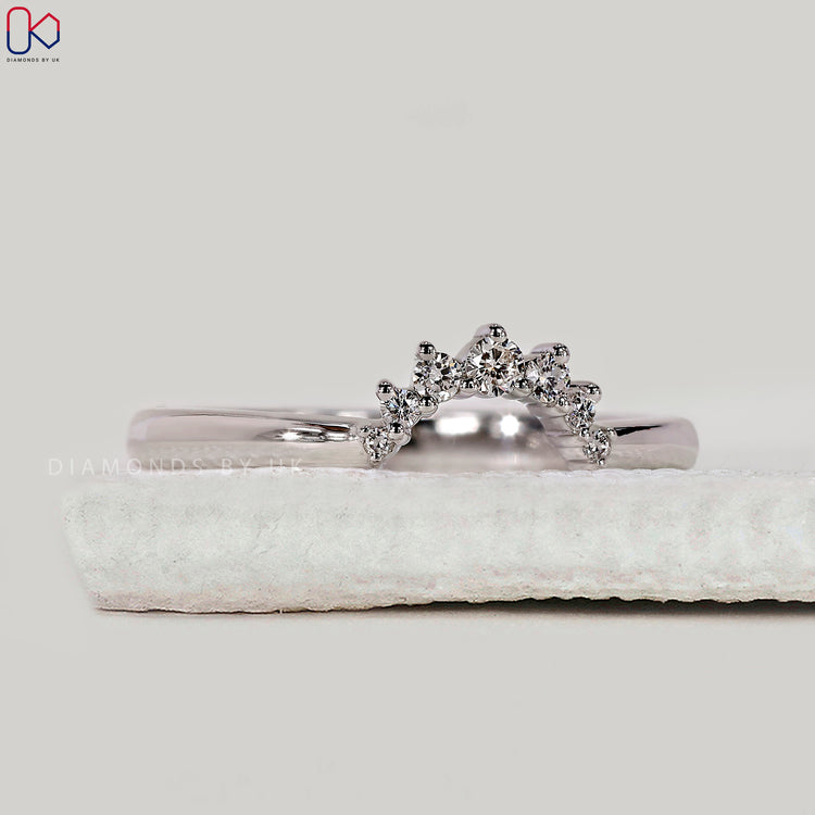 Yellow gold wedding band with prong setting.
