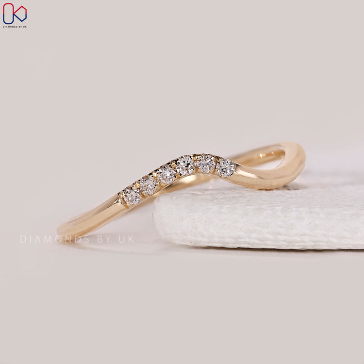 Wave wedding band with round diamonds.
