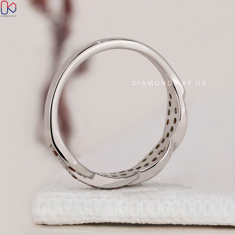 Twisted gemstone wedding band with vibrant stones for a personal touch.
