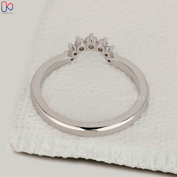 Dainty wedding band with round diamonds.
