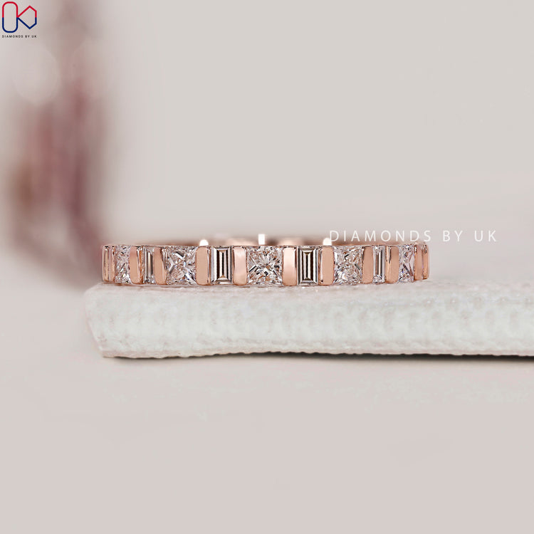 Rose gold band featuring baguette and princess diamonds.
