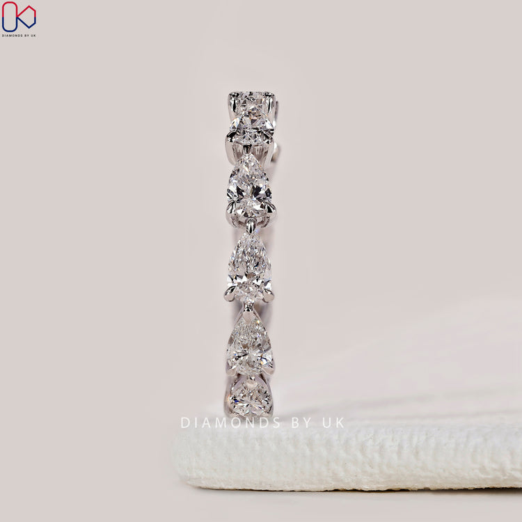Handmade pear shaped diamond band by DiamondsbyUK.

