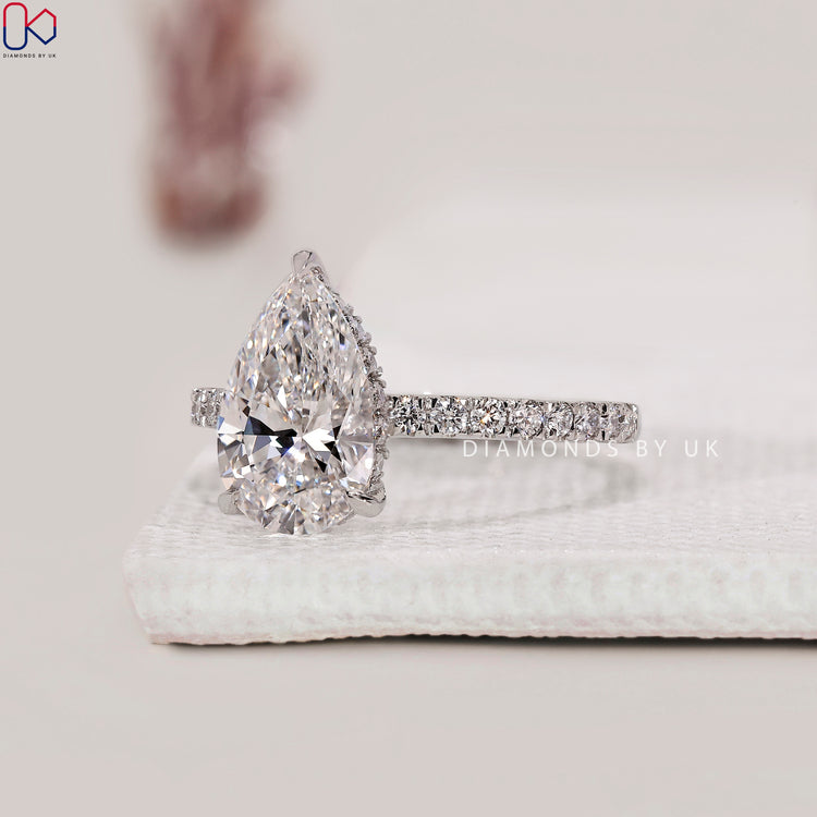 3 claw prong ring showcasing a pear cut diamond.
