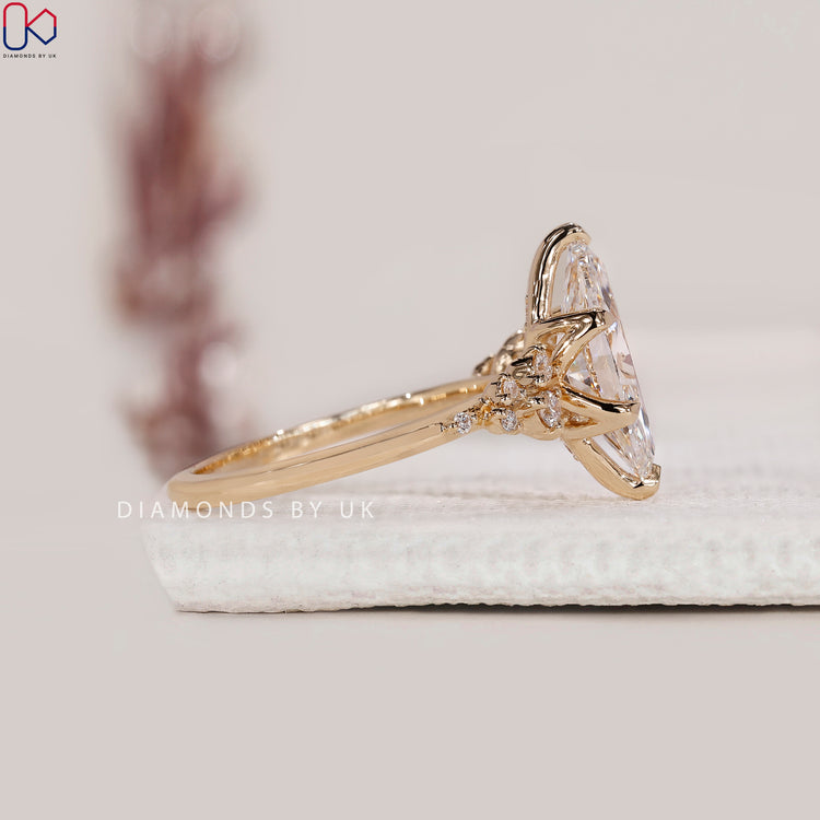 Round side stone yellow gold engagement ring.
